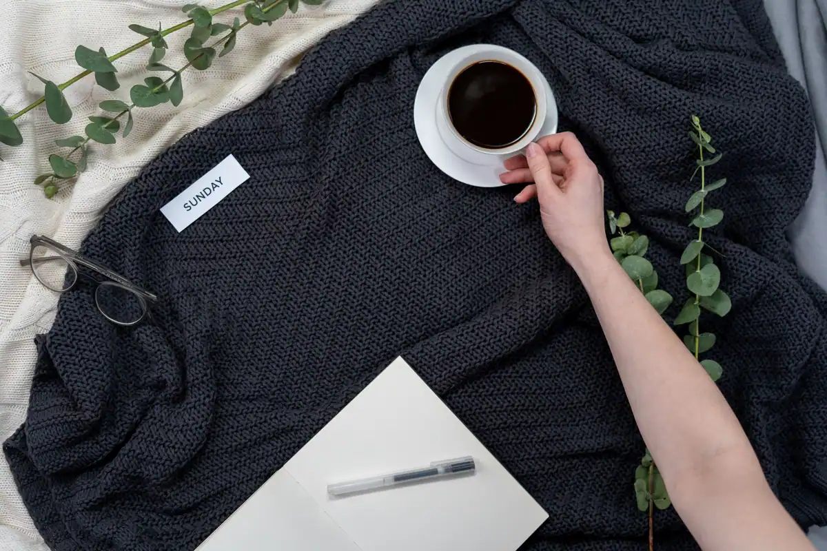 Dimineață de duminică relaxată, cu cafea, carnet și ochelari pe o pătură